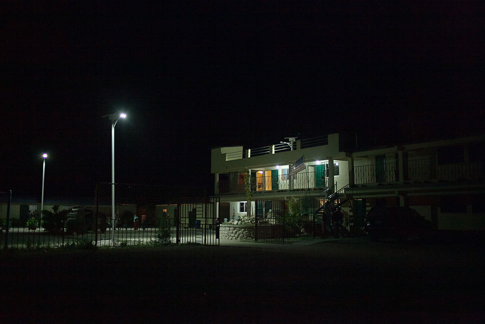 The orphanage before the generator shuts off for the night, and an eerie darkness sets in over the land.