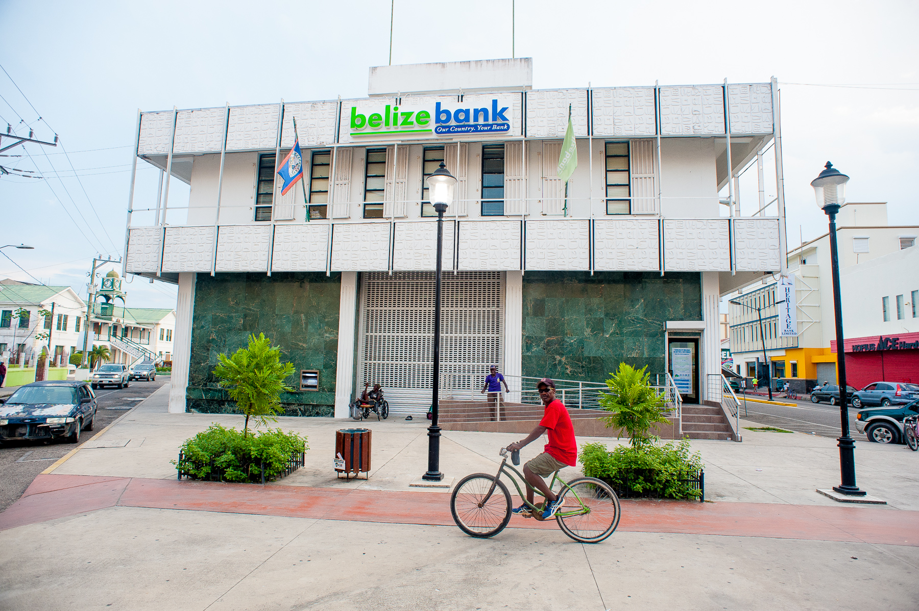 CAPTION: A cyclist rides past Belize Bank in downtown Belize City, April 23, 2017. Photo courtesy Caribbean Network Operators Group.