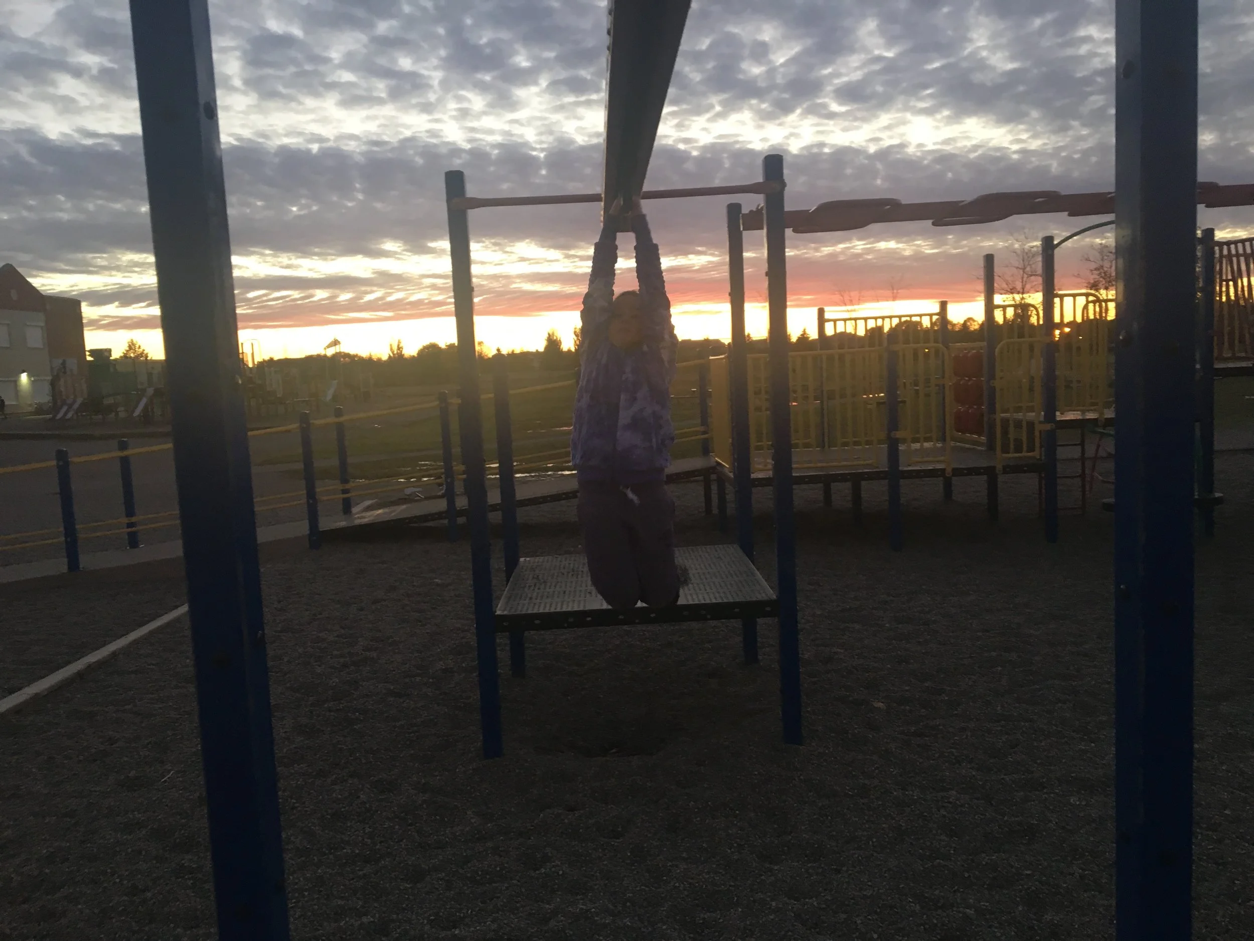 A little sunset climb on the playground bars