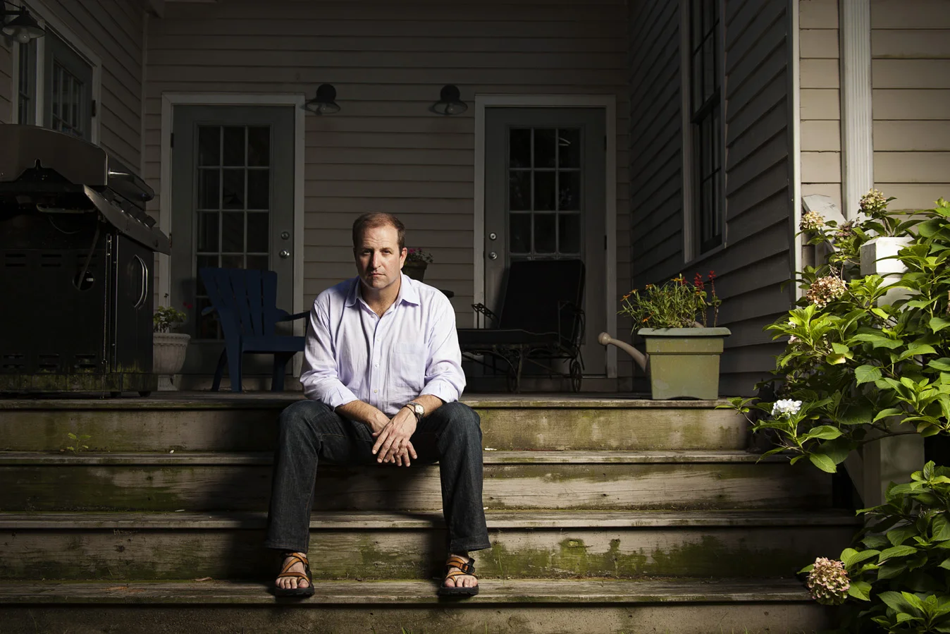 Kinnon sitting on the wood steps of his Midtown Mobile, AL home | Todd Douglas Photography