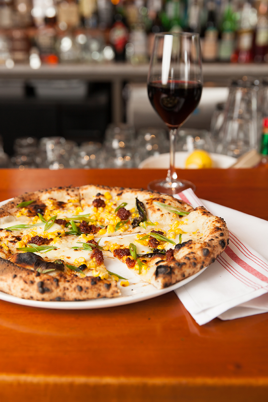 Wood Fired Crab Pizza with Nduja, Bechamel, Basil, and Charred Corn.