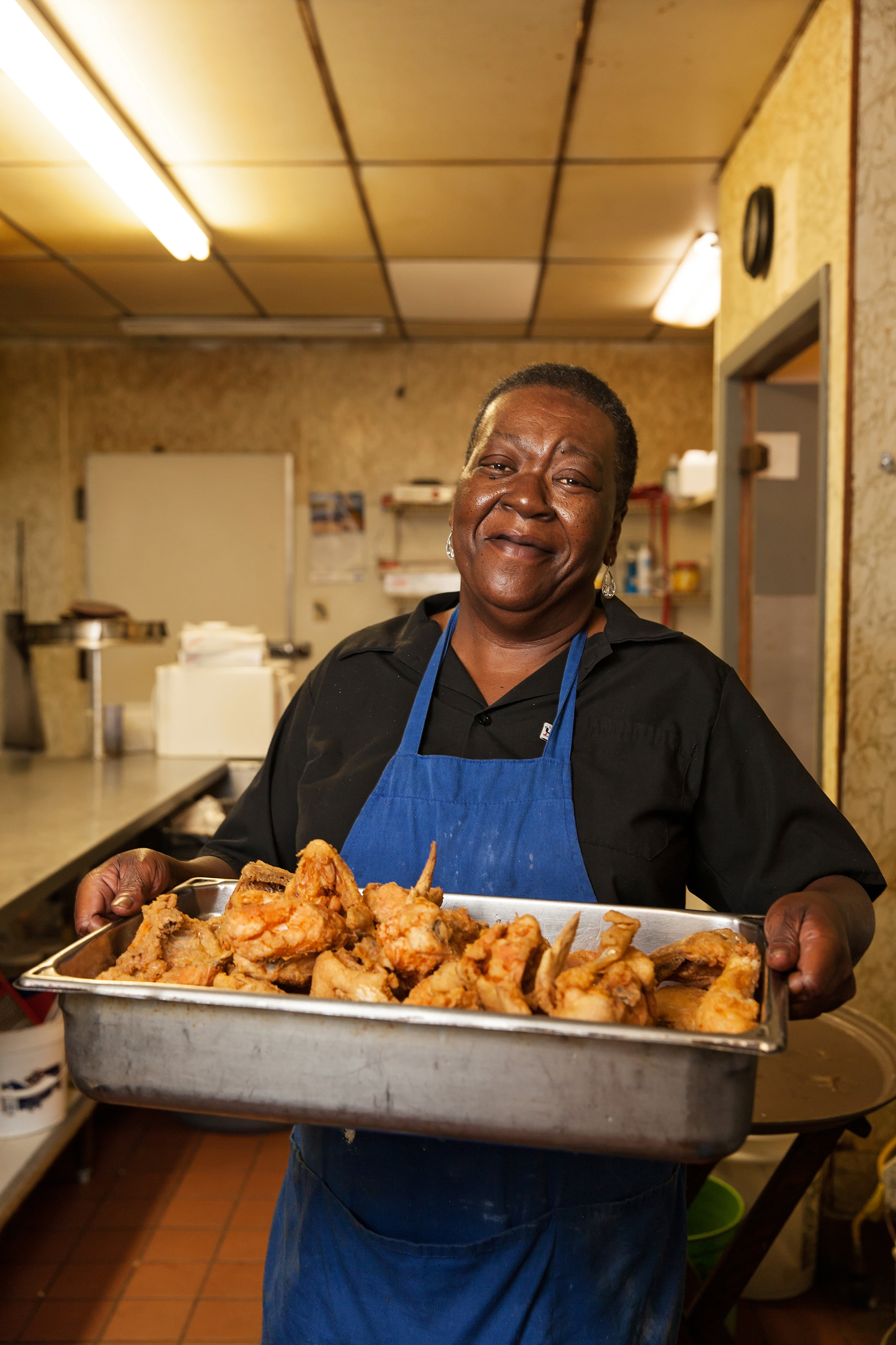 Mrs. Dorothy presents a fresh batch of friend chicken at Mama Lou's Restaurant in Robertsdale, Alabama. 