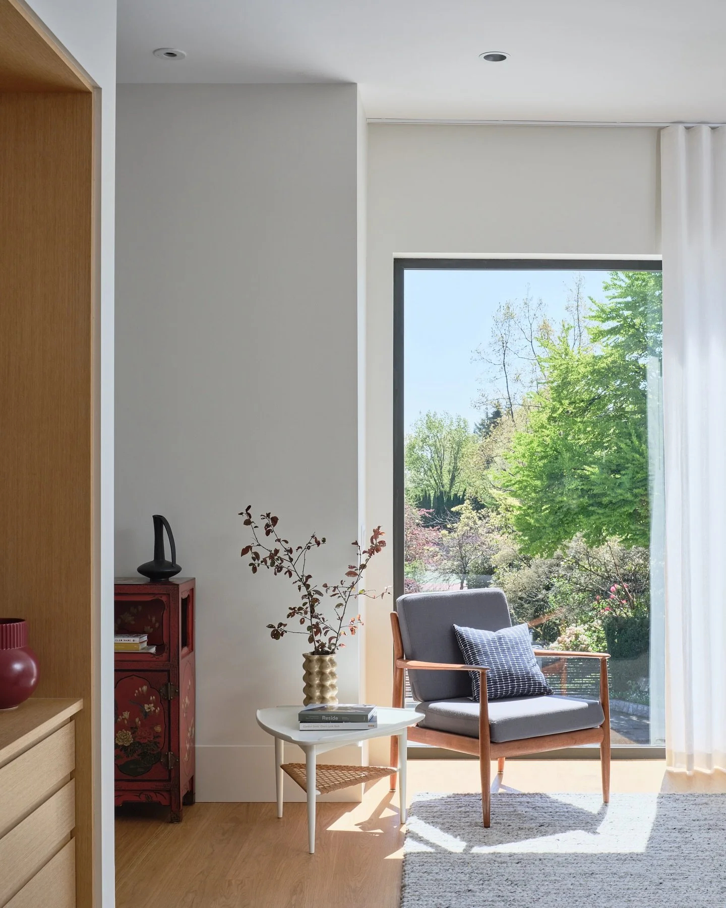 The long view in a newly completed home for a young family in Vancouver.  The typical lot in Vancouver constraints the buildable envelope to set front and rear yards. The design of windows to capture the long views can help to extend the eye and livi
