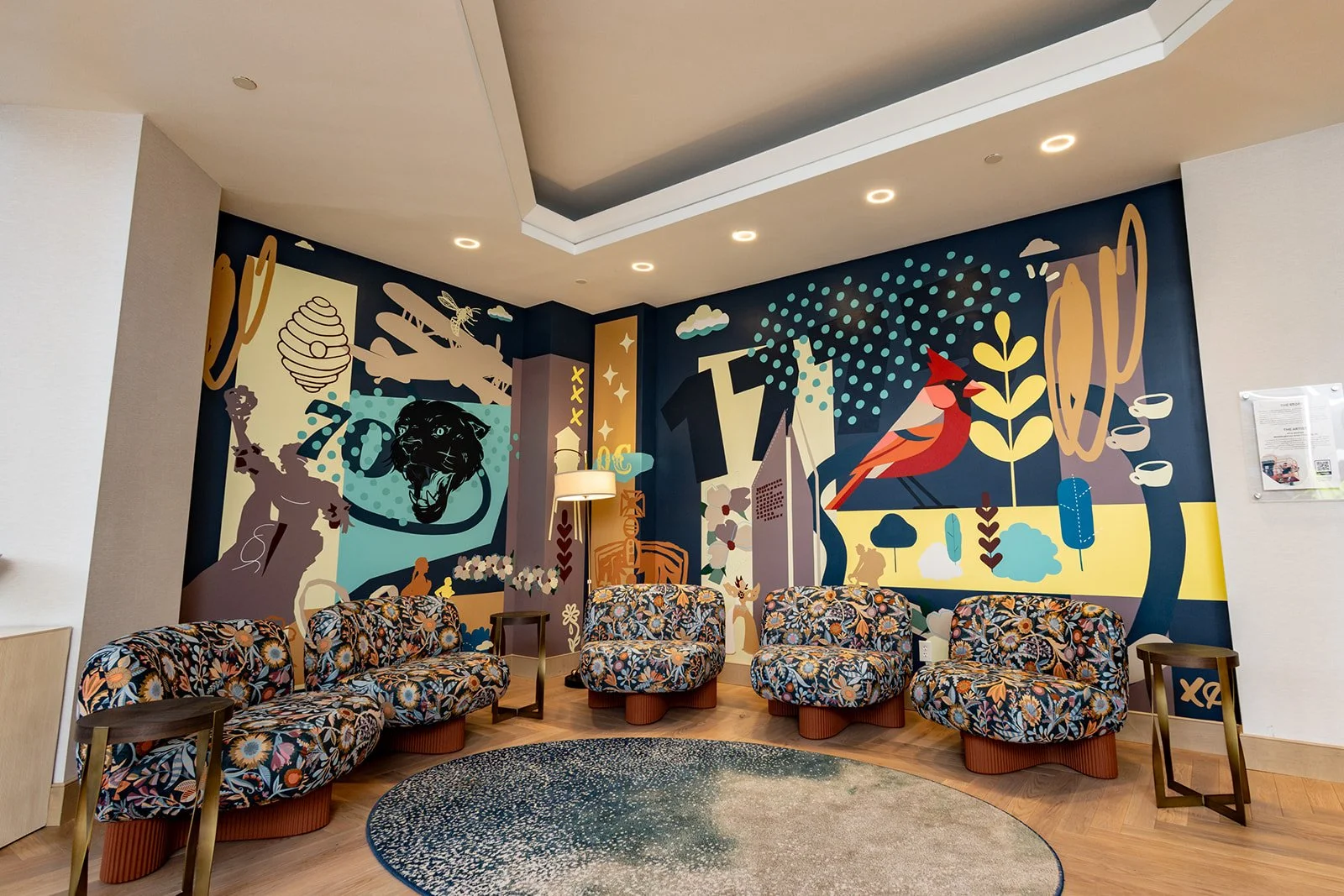 Custom hand-painted lobby mural by Charlotte mural artist Kyle Mosher at the Renaissance Charlotte SouthPark Hotel featuring layered illustrations inspired by Charlotte's culture, architecture, aviation, wildlife, and local landmarks.