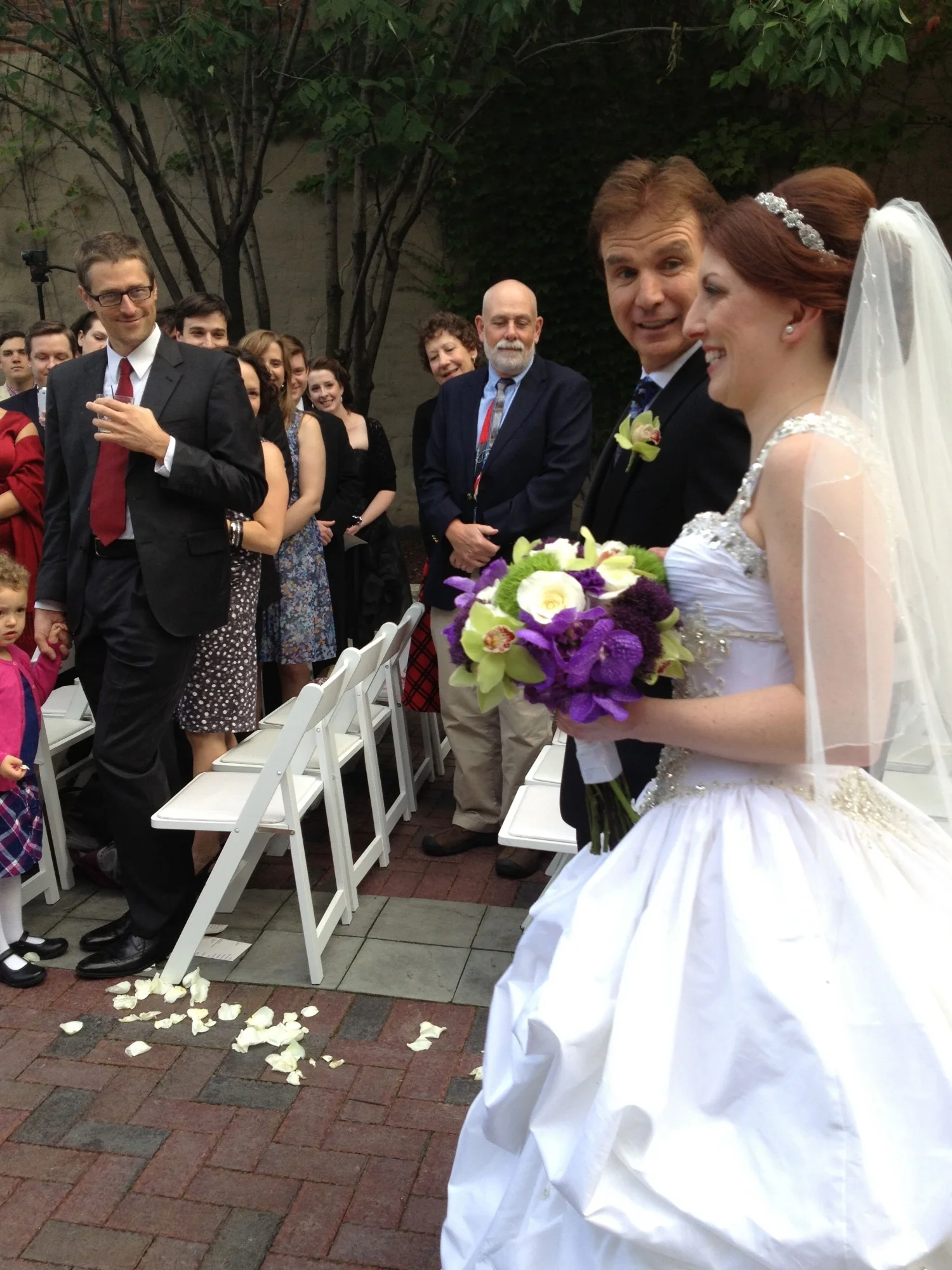 The happy bride walking down the aisle with her dad (and her bouquet!) 