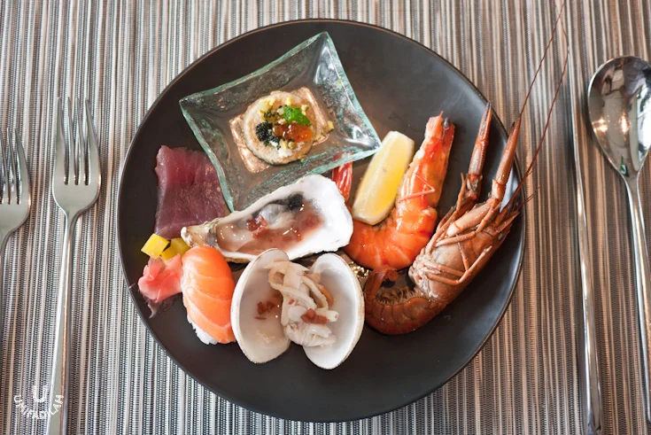 My plate from the Seafood Bar: Blinis (Russian buckwheat pancake) with Salmon Roe/Ikura &amp; Tobiko/flying fish roe on top, Oysters on the half shell with red wine vinegar &amp; shallots, Jumbo Prawn, Crayfish, Tuna sashimi &amp; Salmon nigiri sush…