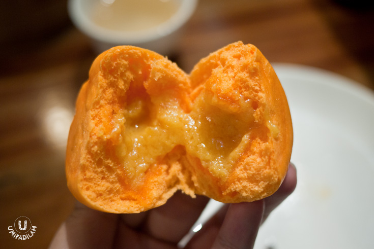 The insides of the steamed bun. Oozing sweet egg yolk mixture!