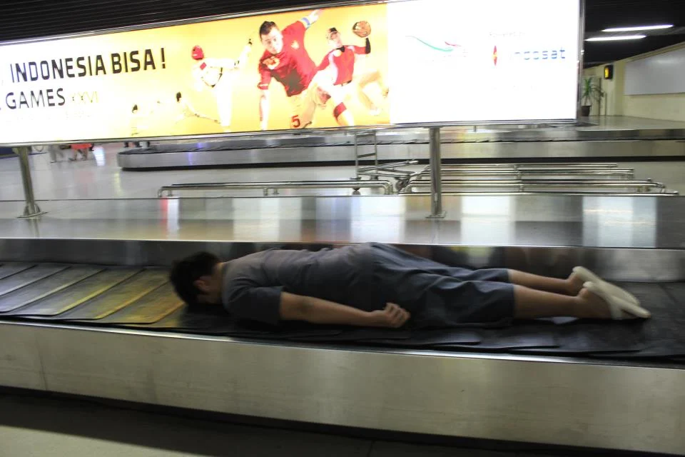 ON AN AIRPORT BAGGAGE'S TRAVELATOR. (which he almost got chased by the airport security...lol)