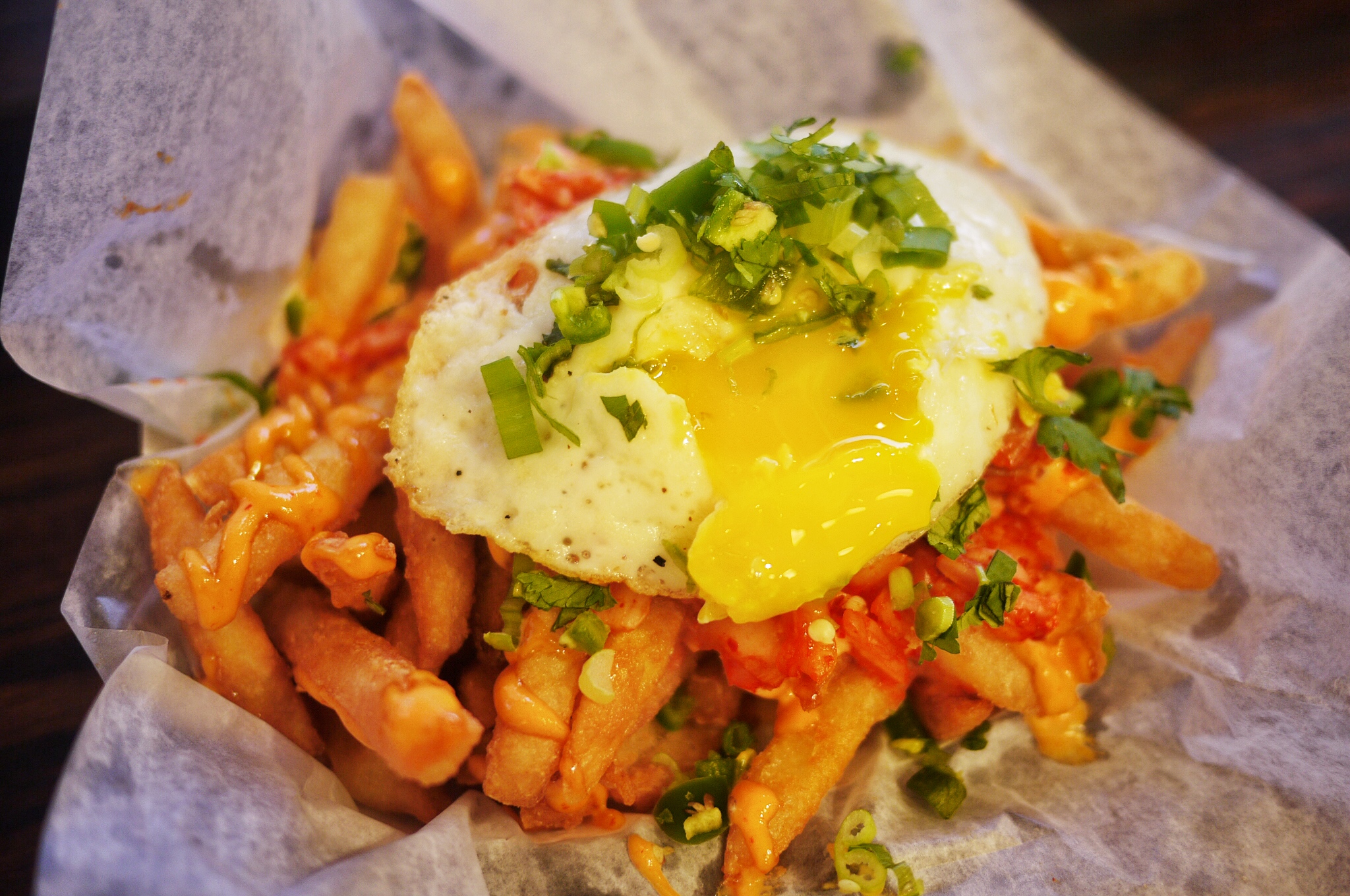 Loaded Kimchi Fries $5.99. Seasoned and battered French fries topped with mild spicy mayo, mild kimchi, chopped scallions, cilantro and jalapenos, and then topped with fried runny egg. HELL YEAH THIS THING IS GOOD! The portion is enough for sharing up to 3 people, so worth the price.
