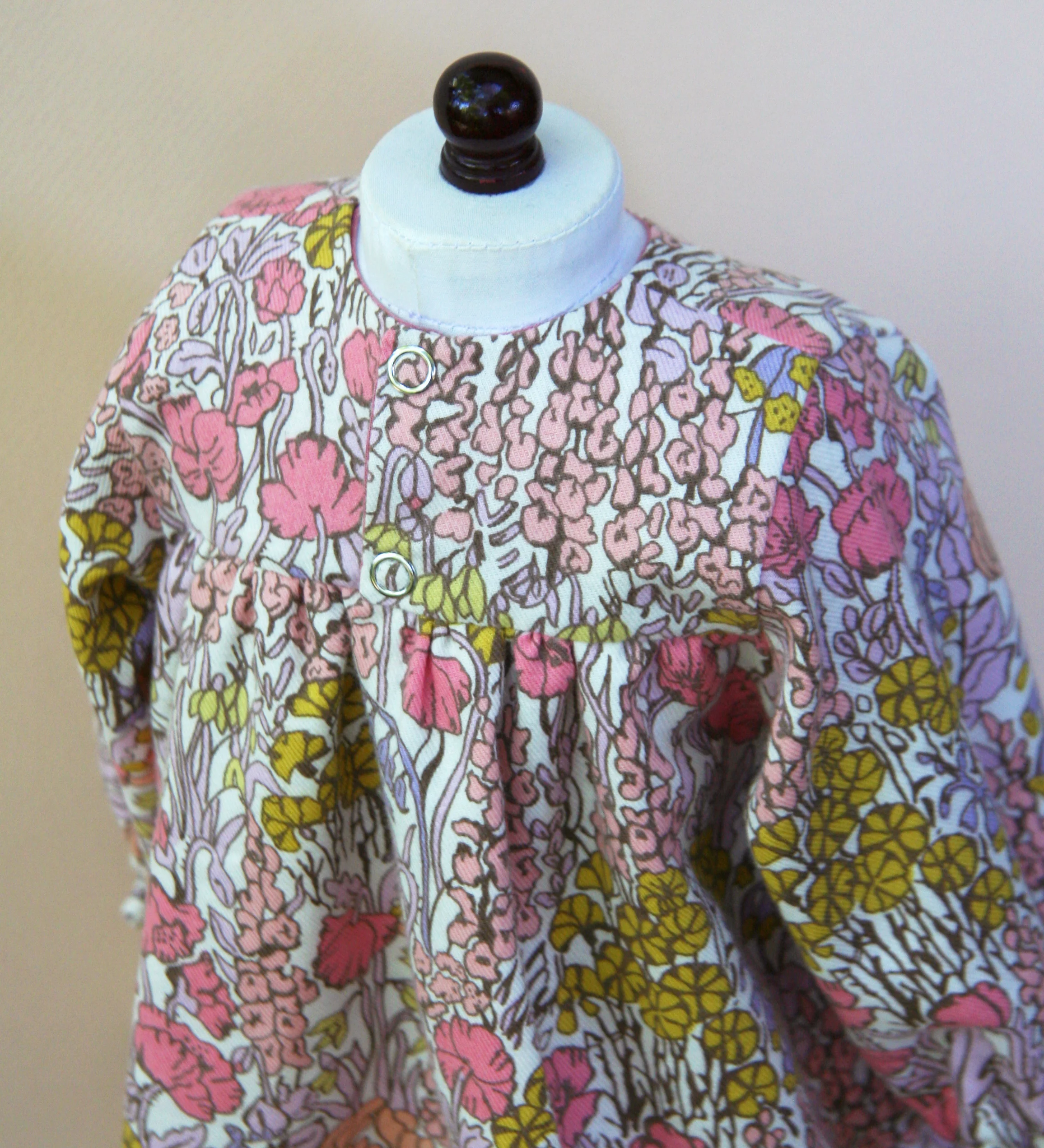 Opens in the back with snap closures for easy dressing