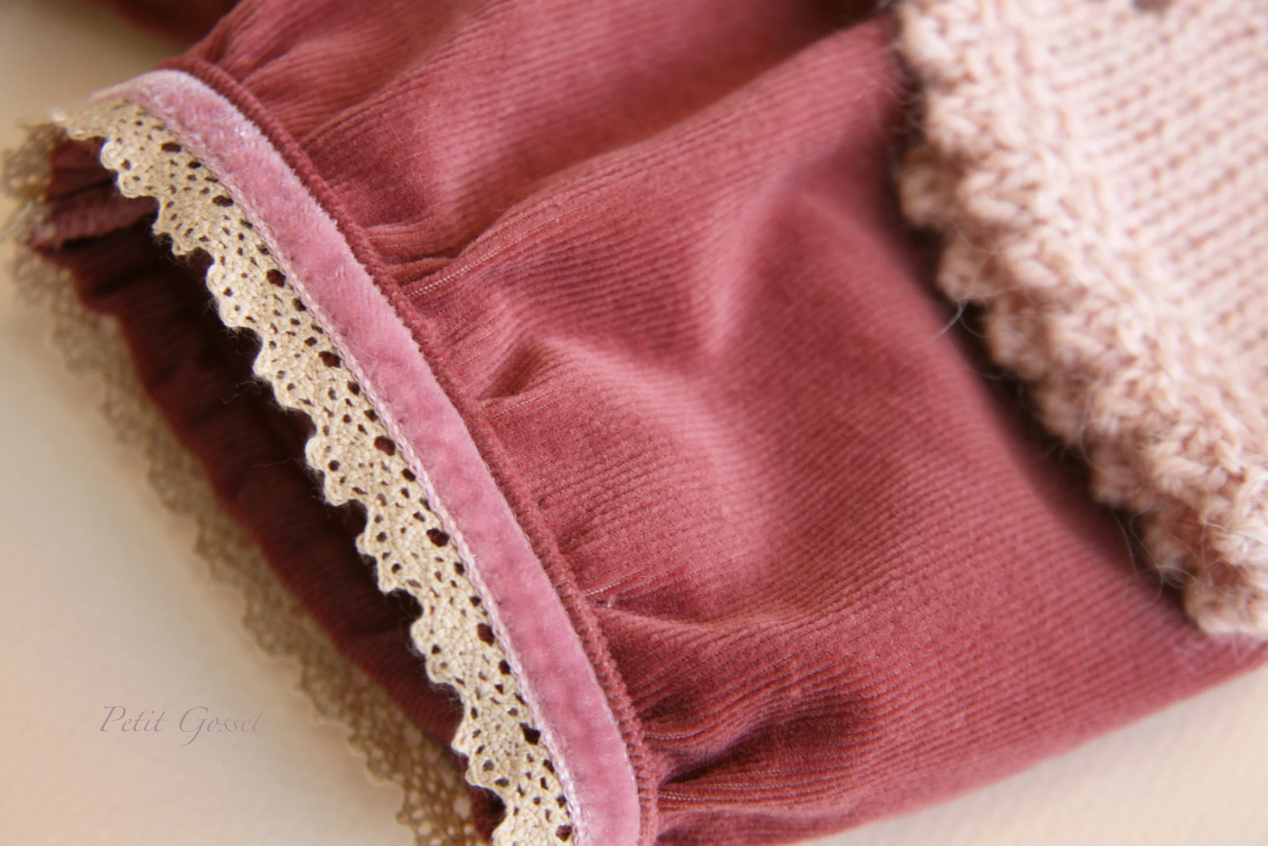 The corduroy knee-length pants feature lovely cotton lace trim.