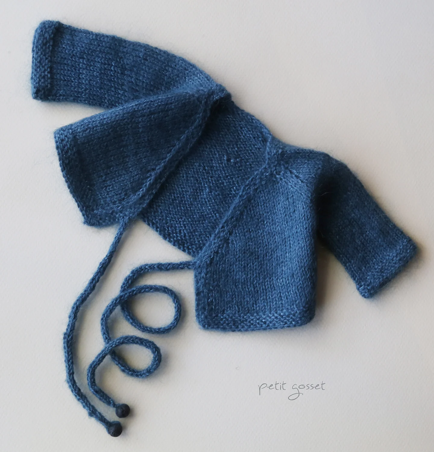 Make the ties on both front panels. The length of the inner tie should be longer (left panel of the sweater) as it goes around the body and comes out through the side hole in the sweater. The approximate lengths of the ties are: 14” and 7” (35cm and 18 cm).
