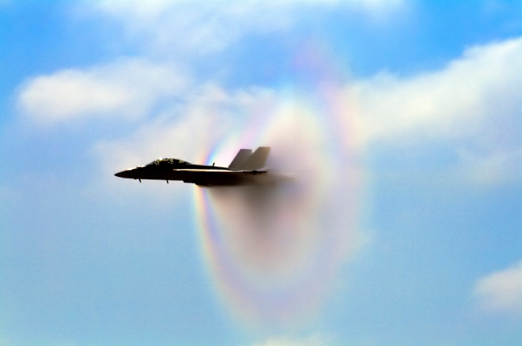 An F/A-18 demonstrates the Prandtl-Glauert singularity (vapor cone near Mach 1) and/or an interdimensional portal