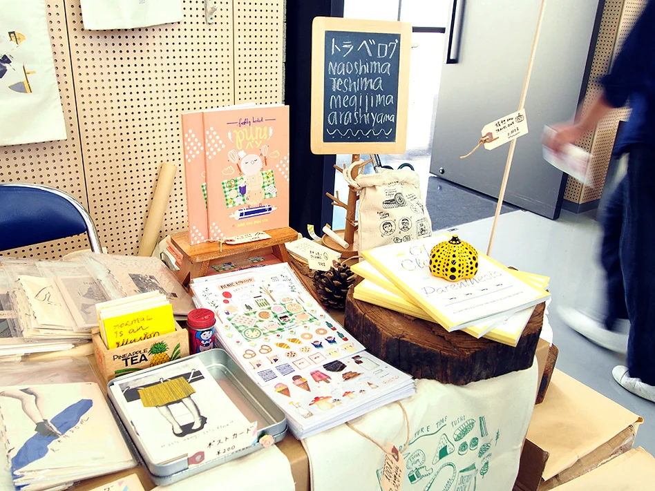 Our tiny booth – I had to balance a merchandises on my head and it helped to draw some crowd.