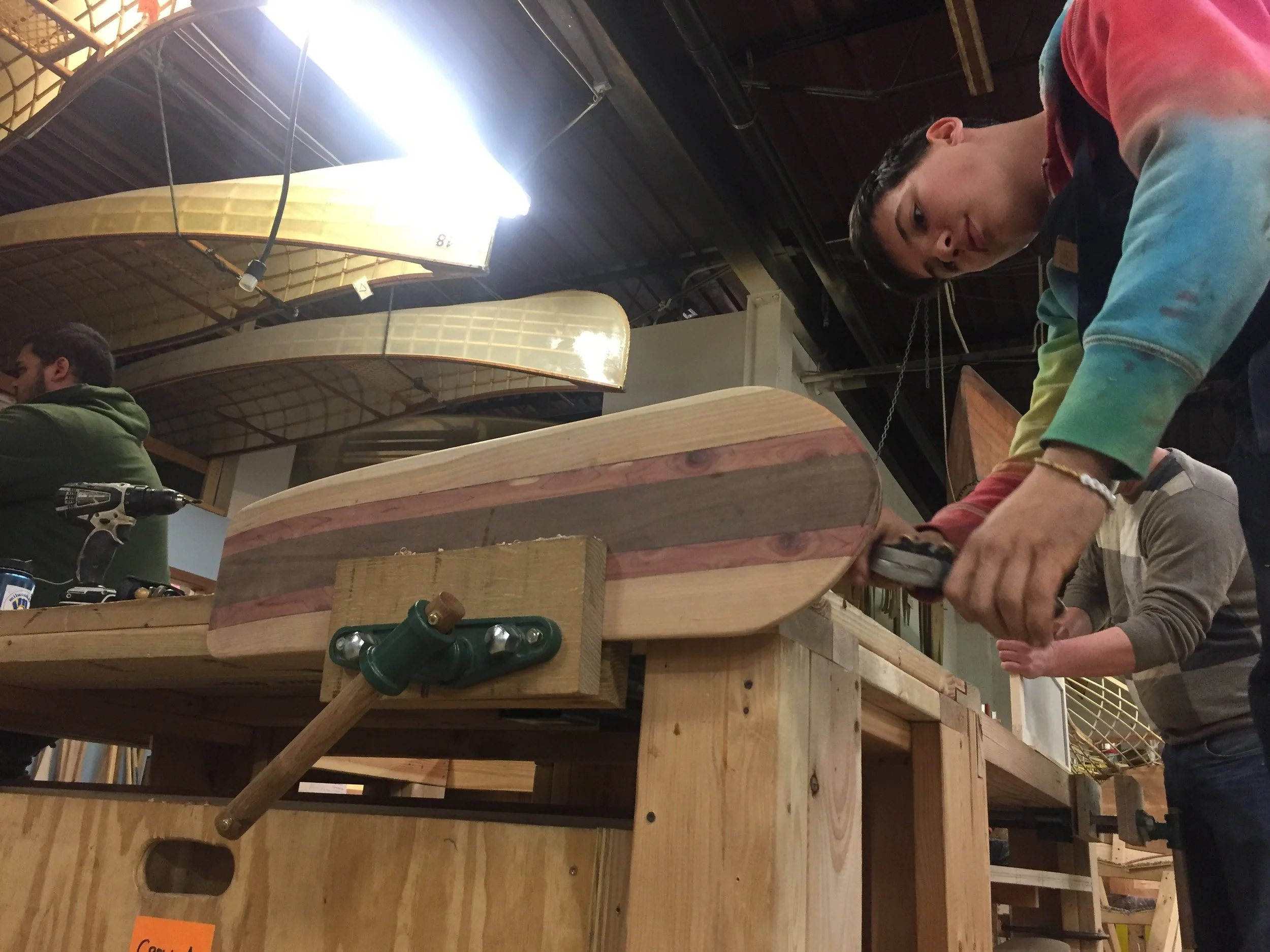 Apprentice Alex works on the skateboard prototype.