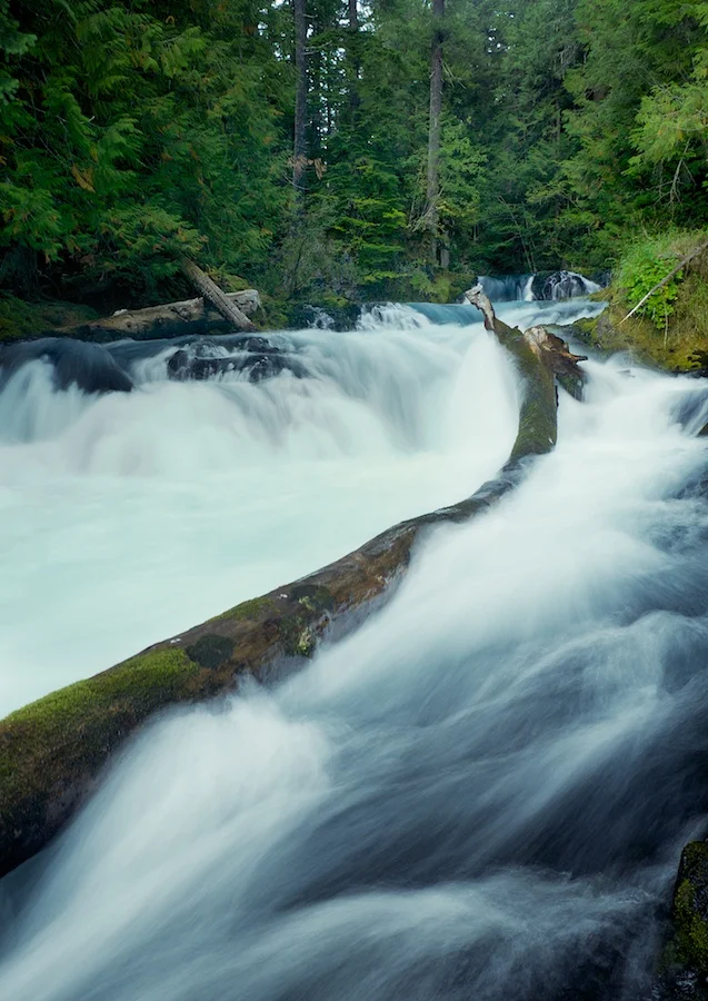 Swift waters above Sahalie Falls, McKenzie River, Oregon. Fuji X-E1, XF 18-55mm @ 18mm. ISO 400, f/18, 1/2 second. 