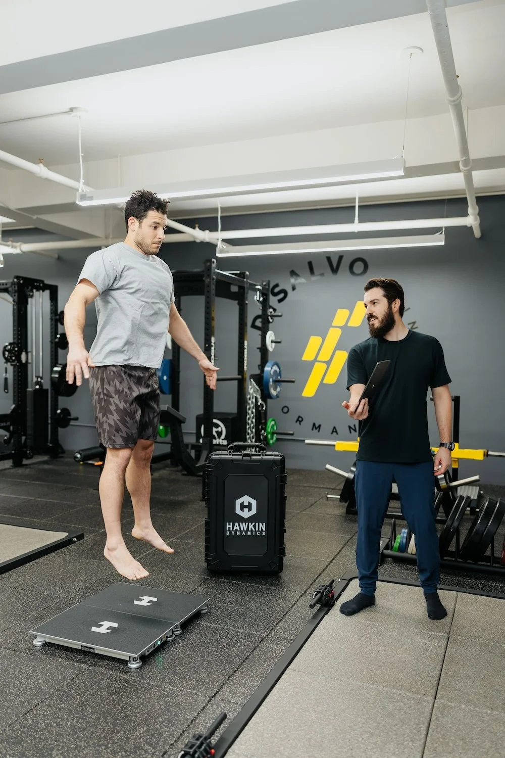 Coach Mark DiSalvo and athlete doing a jump test using Hawkin Dynamics forceplaces