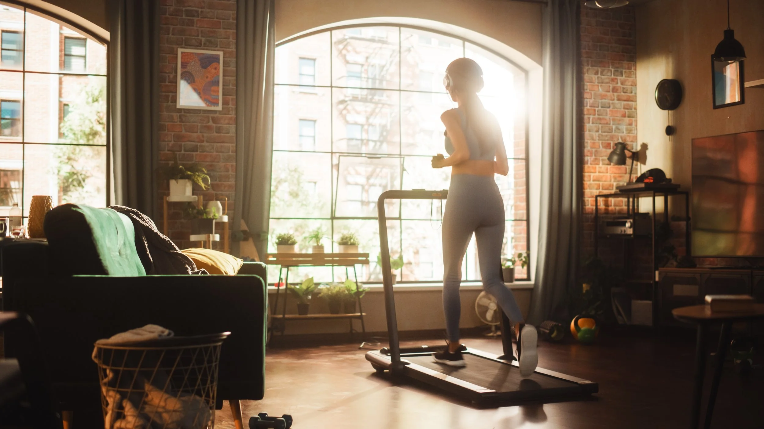 woman on treadmill in front of window