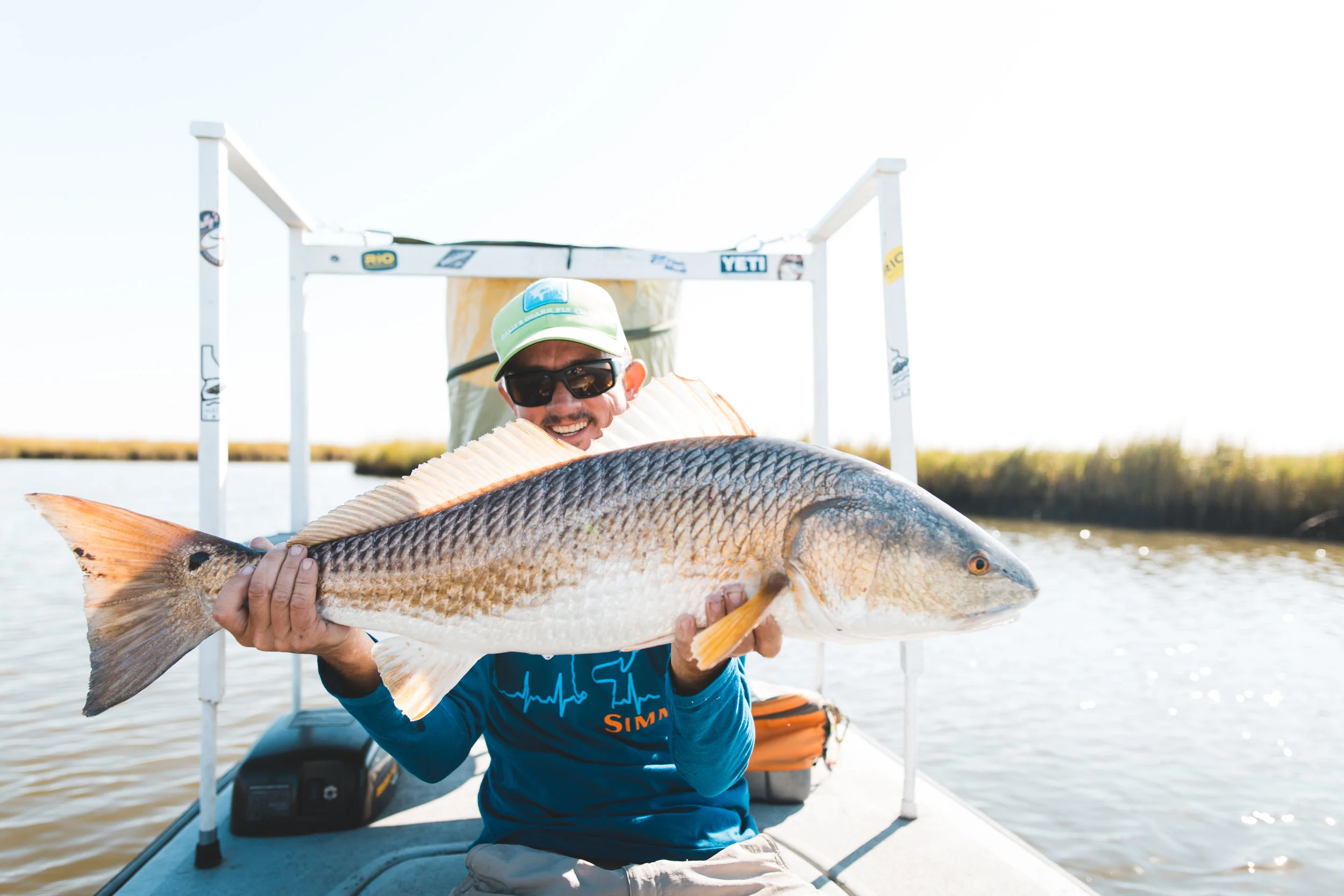 Chad Johnson peeking through the fins of a dandy bull red.