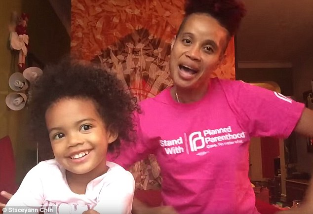 Staceyann Chin with her daughter, Zuri in one of their living room protests. Photo credit and rights: Staceyann Chin. 