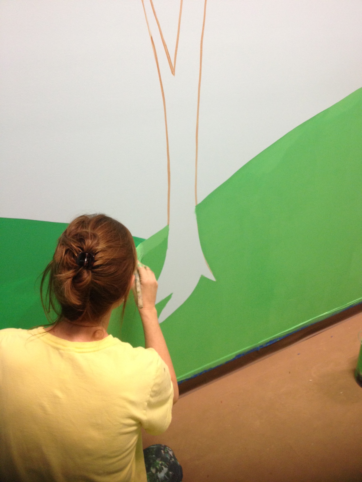 Laura Gross, our fabulous muralist, doing what she does best.