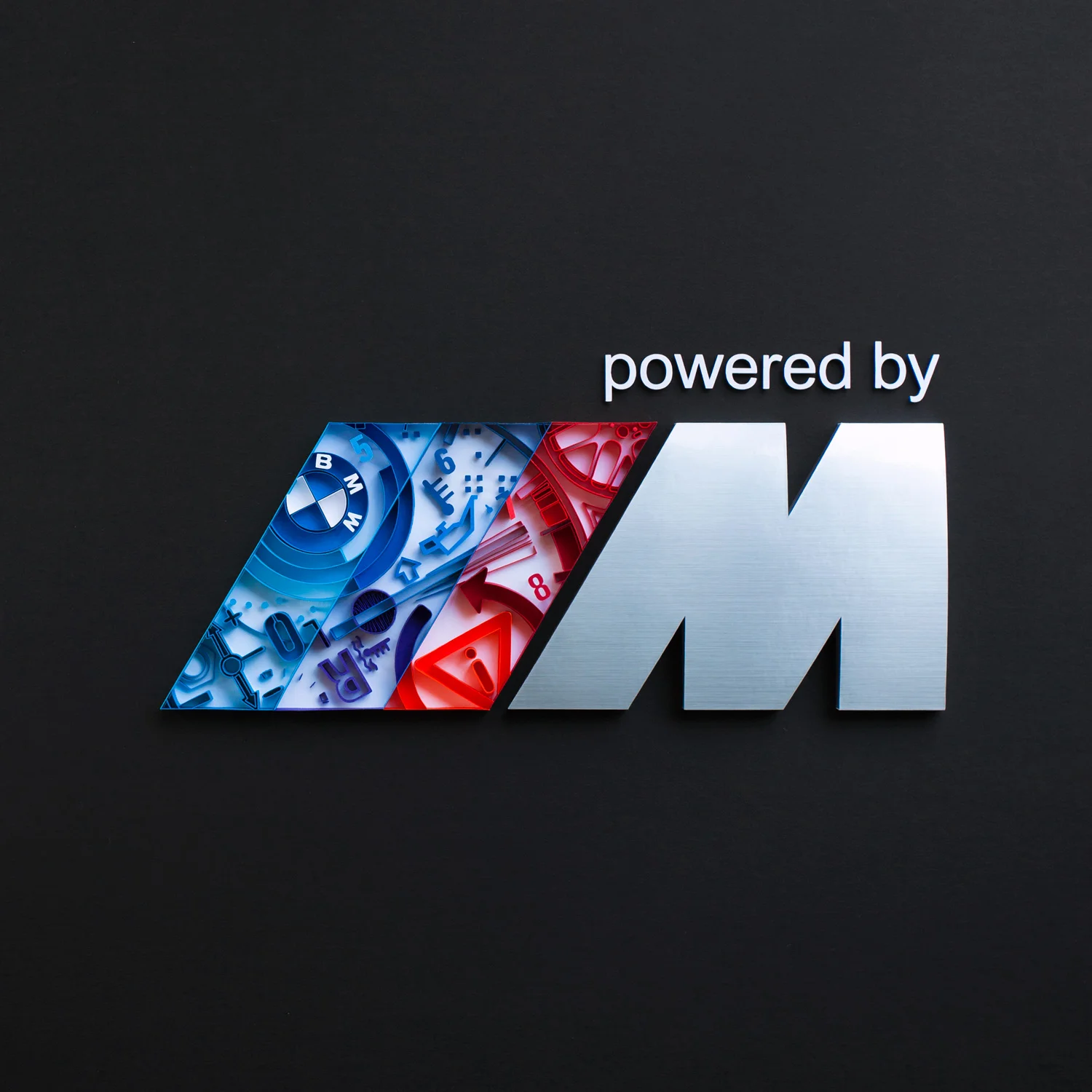 The birth of a Motorsport enthusiast was marked by the first sports car that rolled off the BMW factory in the early 20th century. Enthusiasts, at times, played a fundamental role in shaping the company and fostering growing popularity for motor racing. After spending hours on documentaries, I commend BMW for listening and taking into account opinions of its fans and offering several milestone products that appealed to the very soul of such diverse group of Motorsport lovers. My first (but certainly not the last) M experience was behind the wheel of an E36 M3. It was somewhere around 6000 rpm in second gear that I realized how BMW M is not just another sports car – not only does M stand for Motorsport, but it is an embodiment of adrenaline-generating thrill, mathematic precision, magnetic beauty, as well as raw and analog feel that connects the driver to the very machine she/he is operating. Being an artist and a math teacher, as well as having a die-hard enthusiast as a husband, it was only a matter of time before I made a Motorsport related artwork. Creating this piece was not easy – I wanted to capture the above mentioned precision and the pleasure of driving throughout various eras of Motorsport. In addition, I wanted my artwork to include easily recognized elements that would excite enthusiasts.