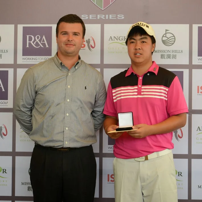 Faldo Series Asia Cambodia champion Putt Sridama of Thailand collects his winner's medal from Angkor Golf Resort director David Baron yesterday. Photo supplied