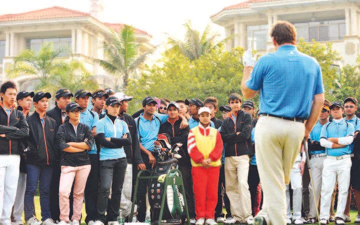 Sir Nick Faldo addresses trainees at a Faldo Series golf clinic.