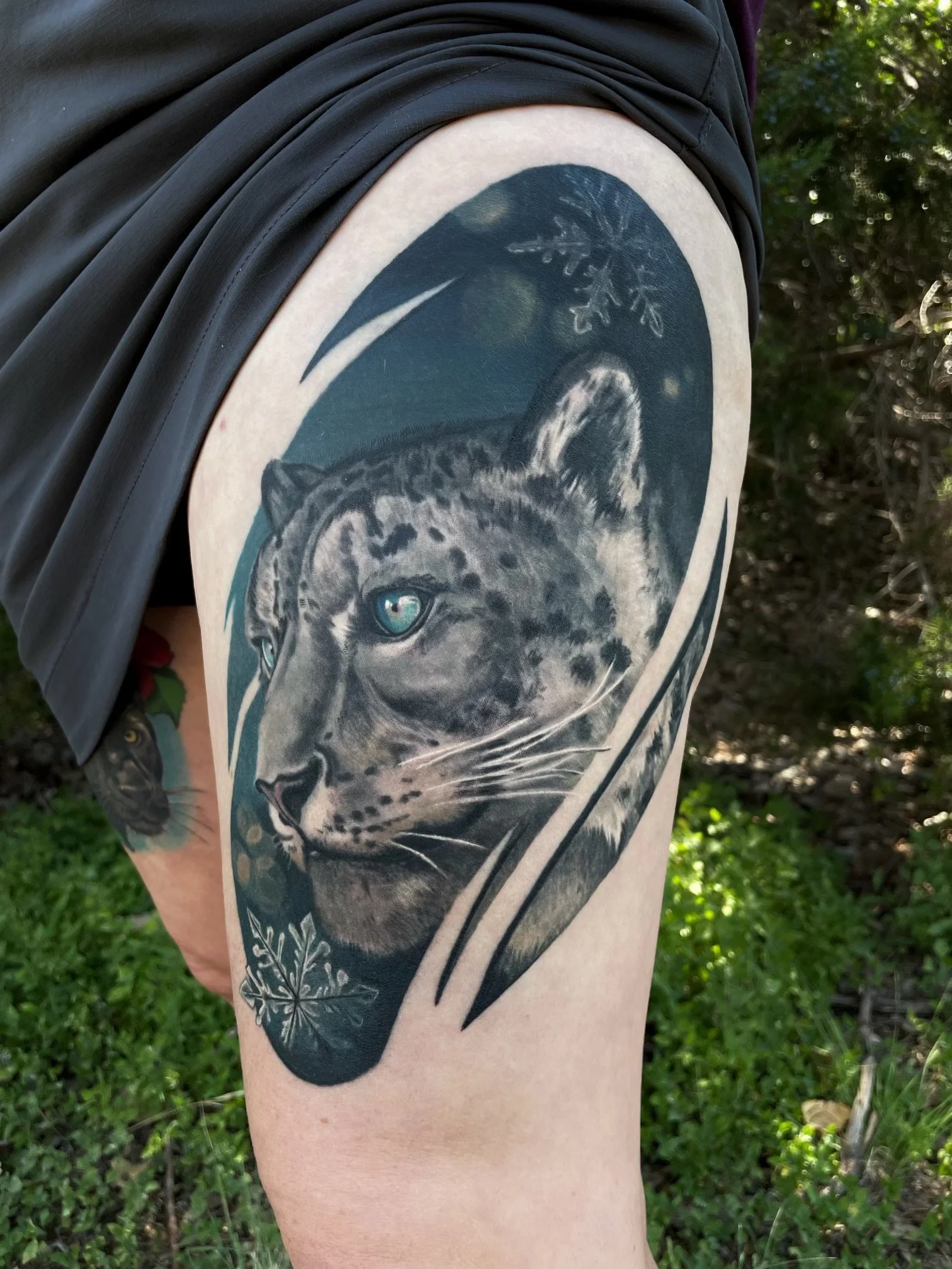 Black and grey snow leopard tattoo on the arm, Austin, by Andrew Matela