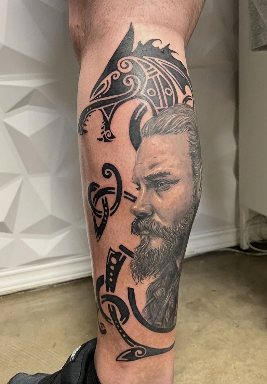 black and grey realism Viking portrait wolf Celtic calf tattoo Austin by Andrew Matela