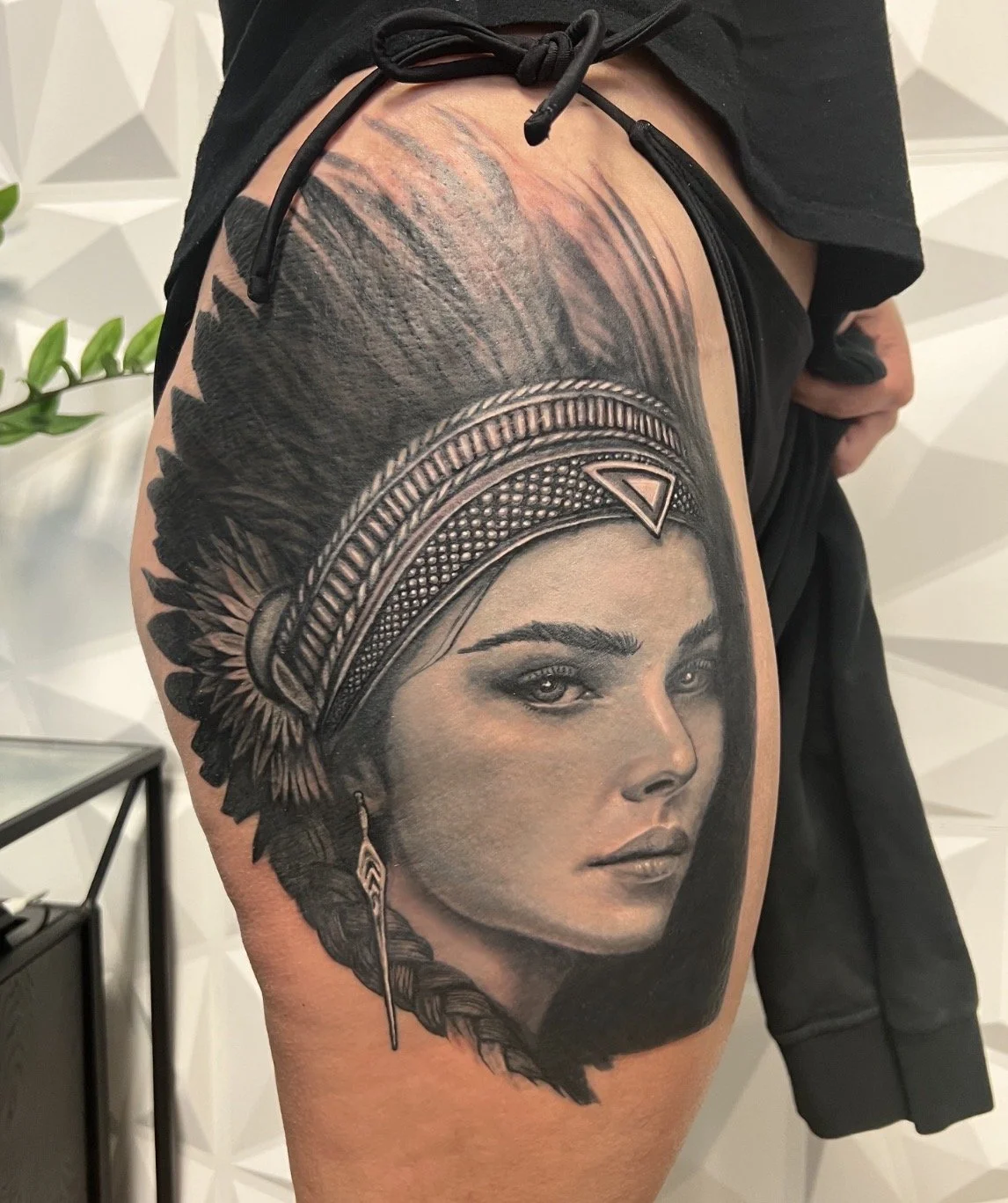black and grey realism Native American headdress woman thigh tattoo Austin by Andrew Matela