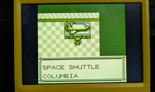 a screenshot of Pokemon Red with a model space shuttle and the text "Space Shuttle Columbia" on the screen