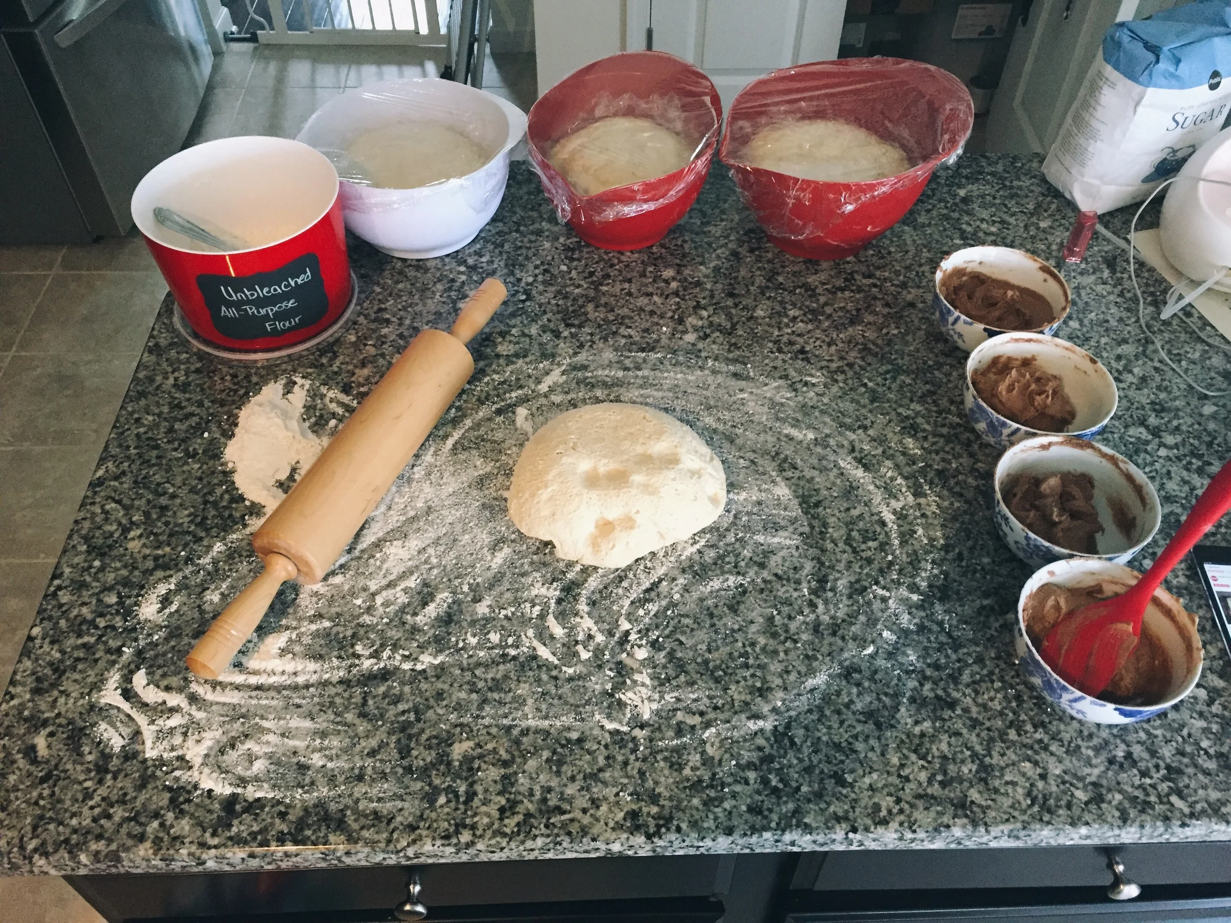 When making this recipe in bulk, I always measure everything for individual recipes instead of trying to do the math to get the dough and filling to multiply. Four bowls of dough, four bowls of cinnamon-sugar butter, four separate recipes that turn into 5 dozen cinnamon rolls. 