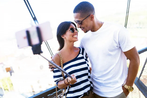 beautiful-young-couple-taking-a-selfie-in-the-street_1301-7264.jpg