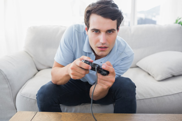 man-having-fun-with-video-games-while-he-is-sat-on-a-sofa_13339-214694.jpg
