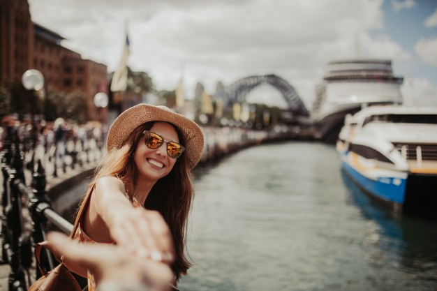 woman-in-sunglasses-holding-boyfriend-hand-while-taking-a-photo-of-her-in-sydney-harbour_1216-536.jpg