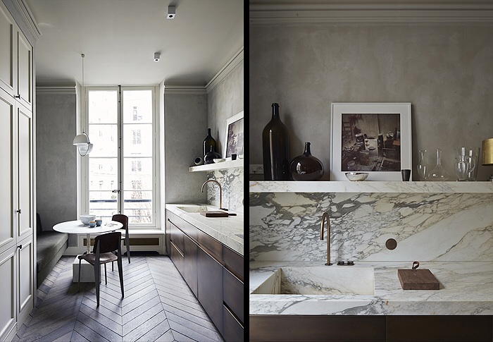 Long slim kitchen with zigzag parquetry, dark timber cupboards and marble bench top splash back and shelf.
