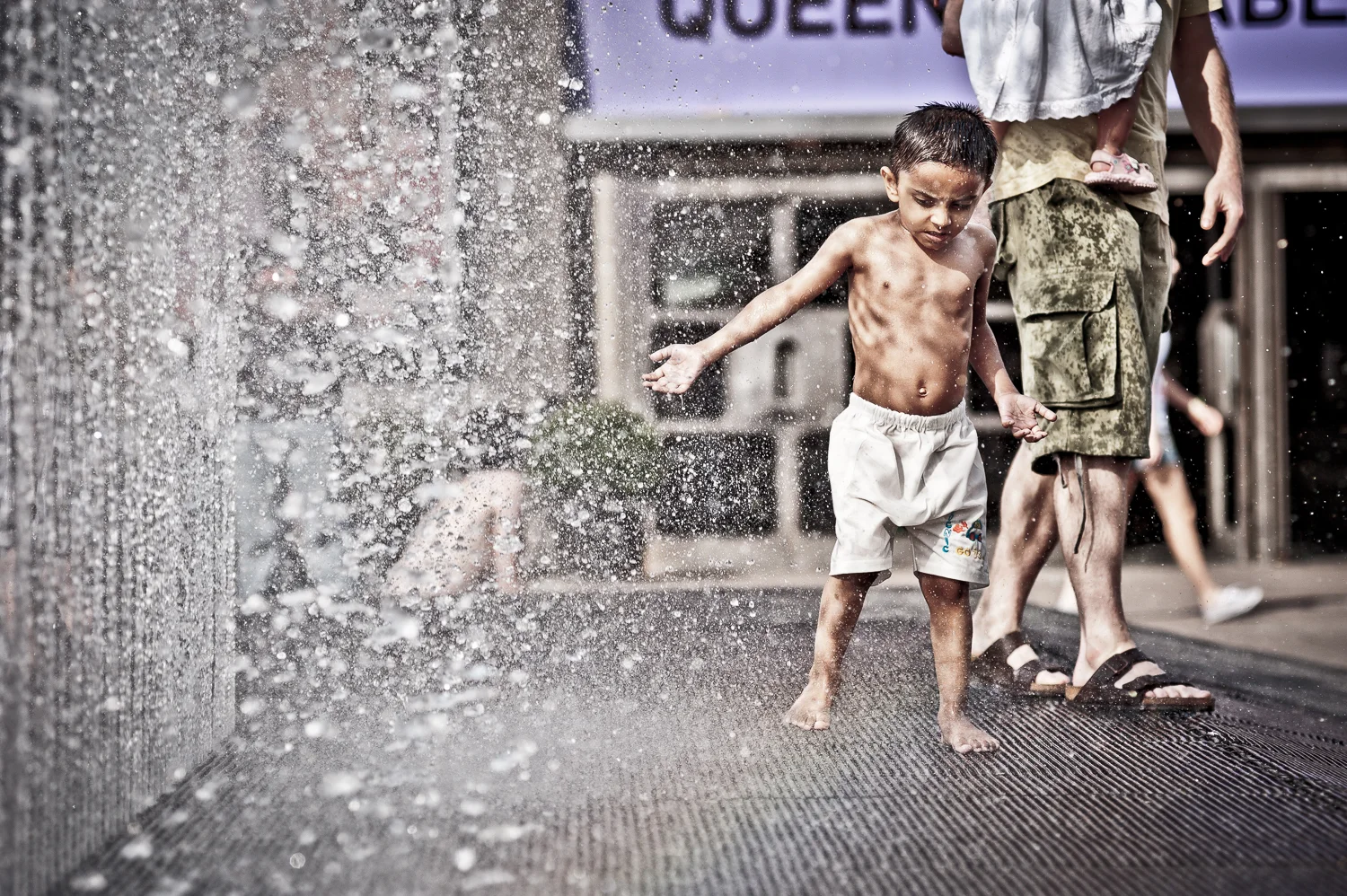 a boy in the fountains on London's Southbank