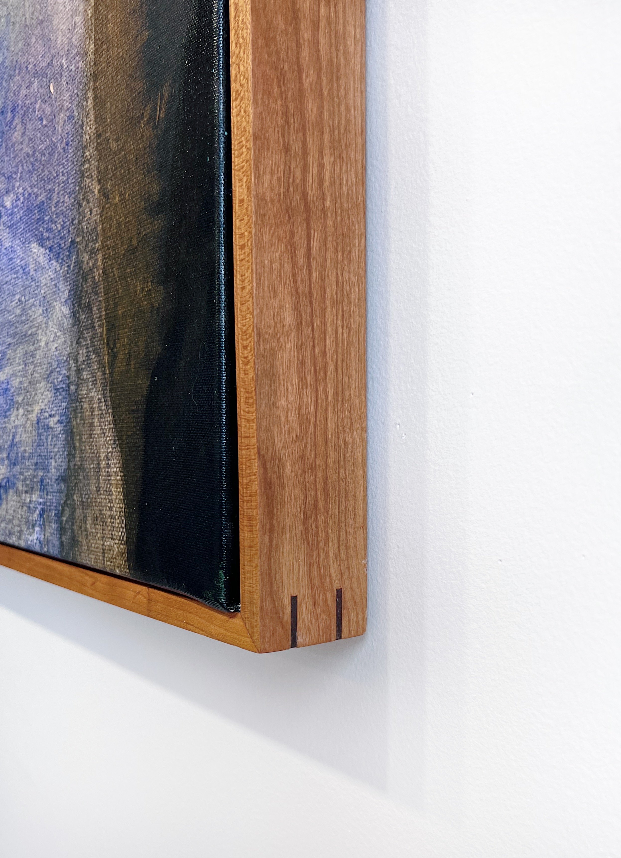 The corner of the Dogtown Canvas fine art print hanging on a wall.