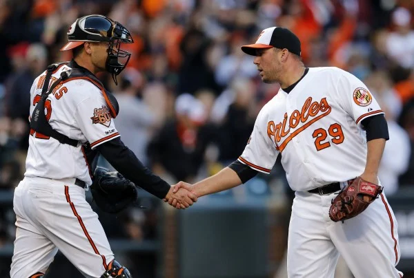 Matt Wieters congratulates Tommy Hunter after sealing a 2-1 Orioles win on Opening Day (Photo Courtesy of Patrick Semansky/Associated Press)