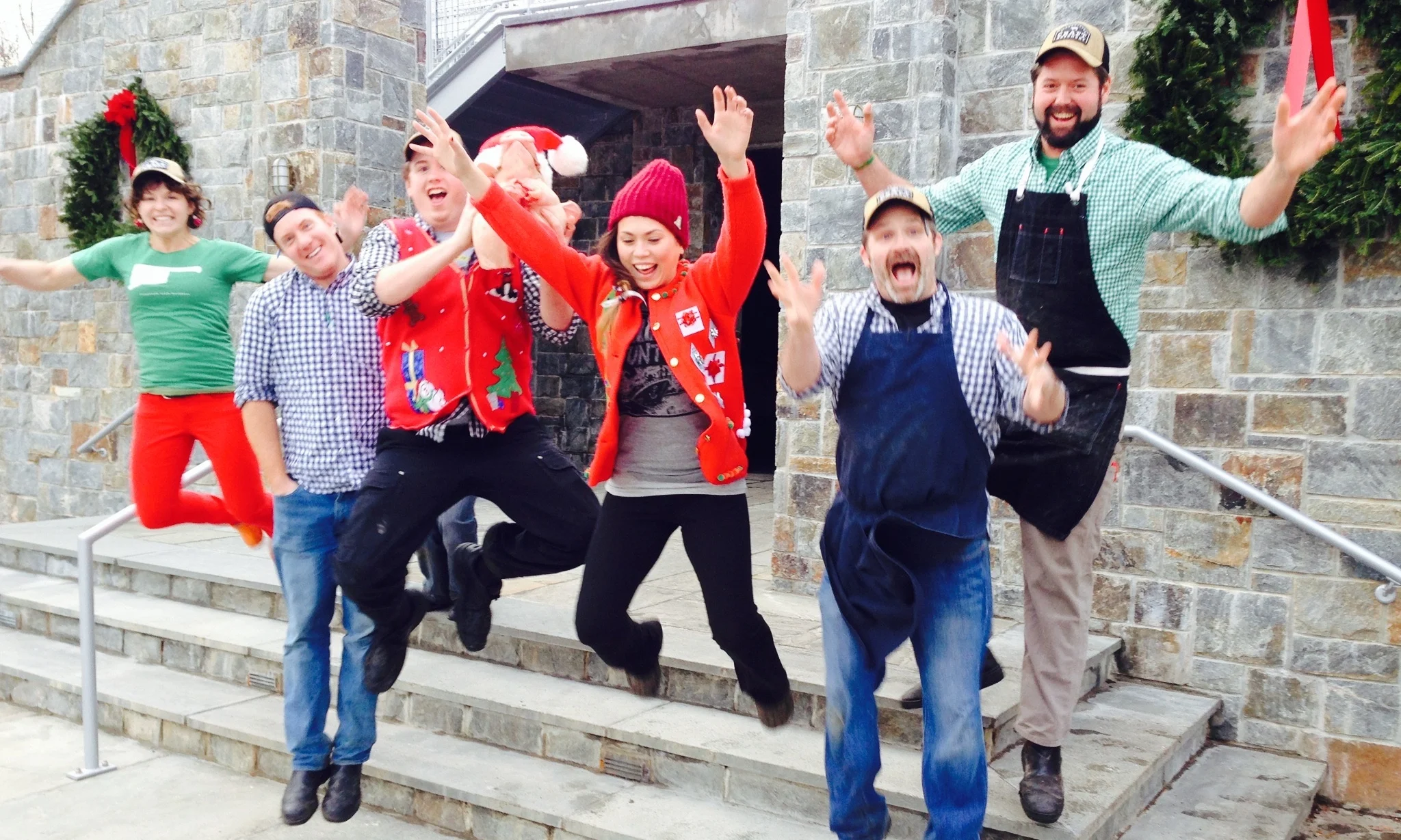 Team wearing holiday gear and jumping
