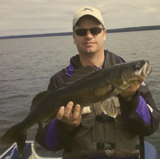 Greg with a 24 inch walleye from Lake Minnitaki, Ontario. The water in this part of Canada looks like iced-tea and the walleye were very dark. Some were nearly black from top to bottom.