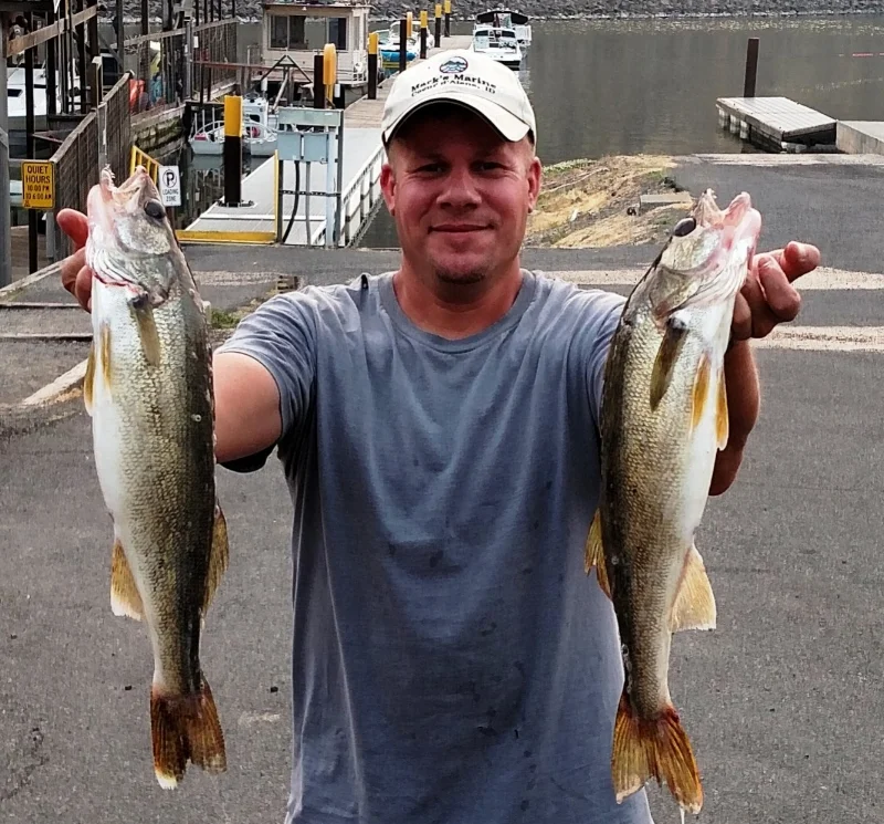 Travis holds a pair of 3 pound walleyes. He caught 5 walleyes on his first trip to the Snake River.