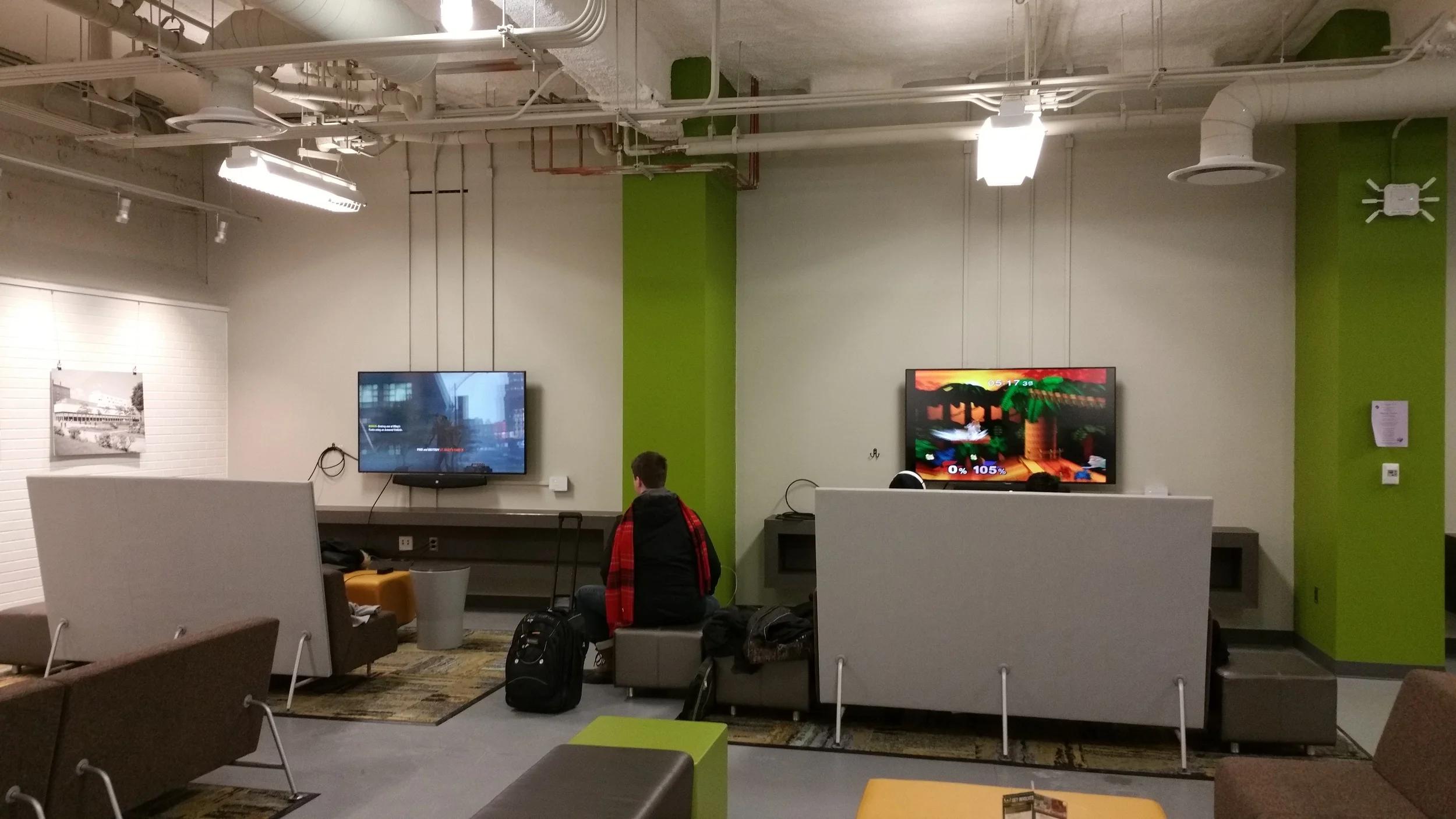 The Student Center at Wayne State University (my grad school) is undergoing a $27 million renovation . One of the new additions is this gaming area with screens and cables, ready to connect to any gaming system or computer.