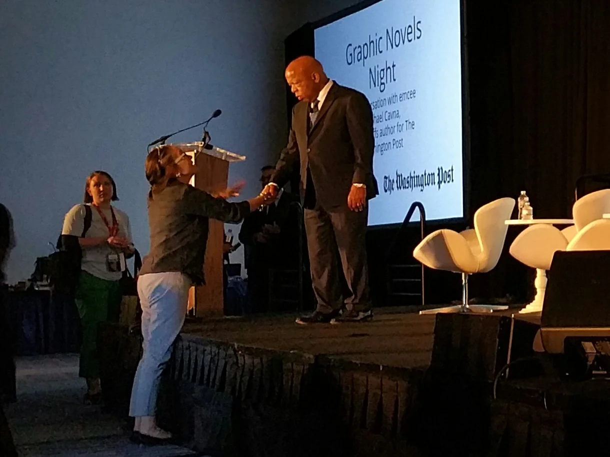 Rep. John Lewis takes a moment to greet an audience member before his talk on his graphic novel series, "March."