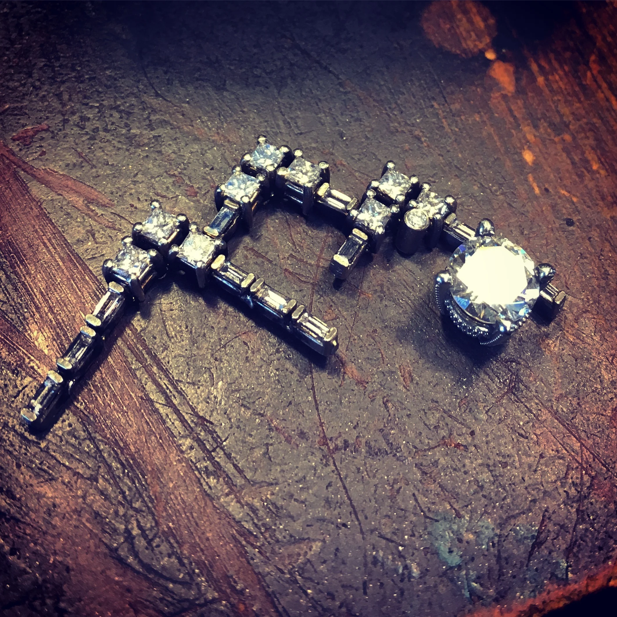 The princess cut diamond and baguettes outline The Three Sisters