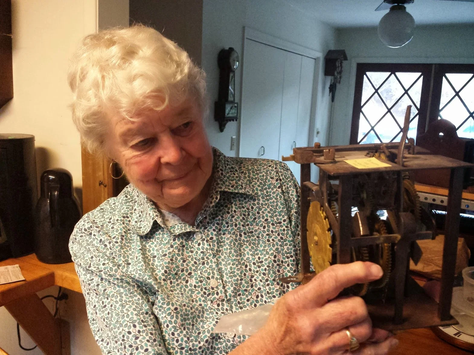 Ginger, with one of the many clocks in her collection.