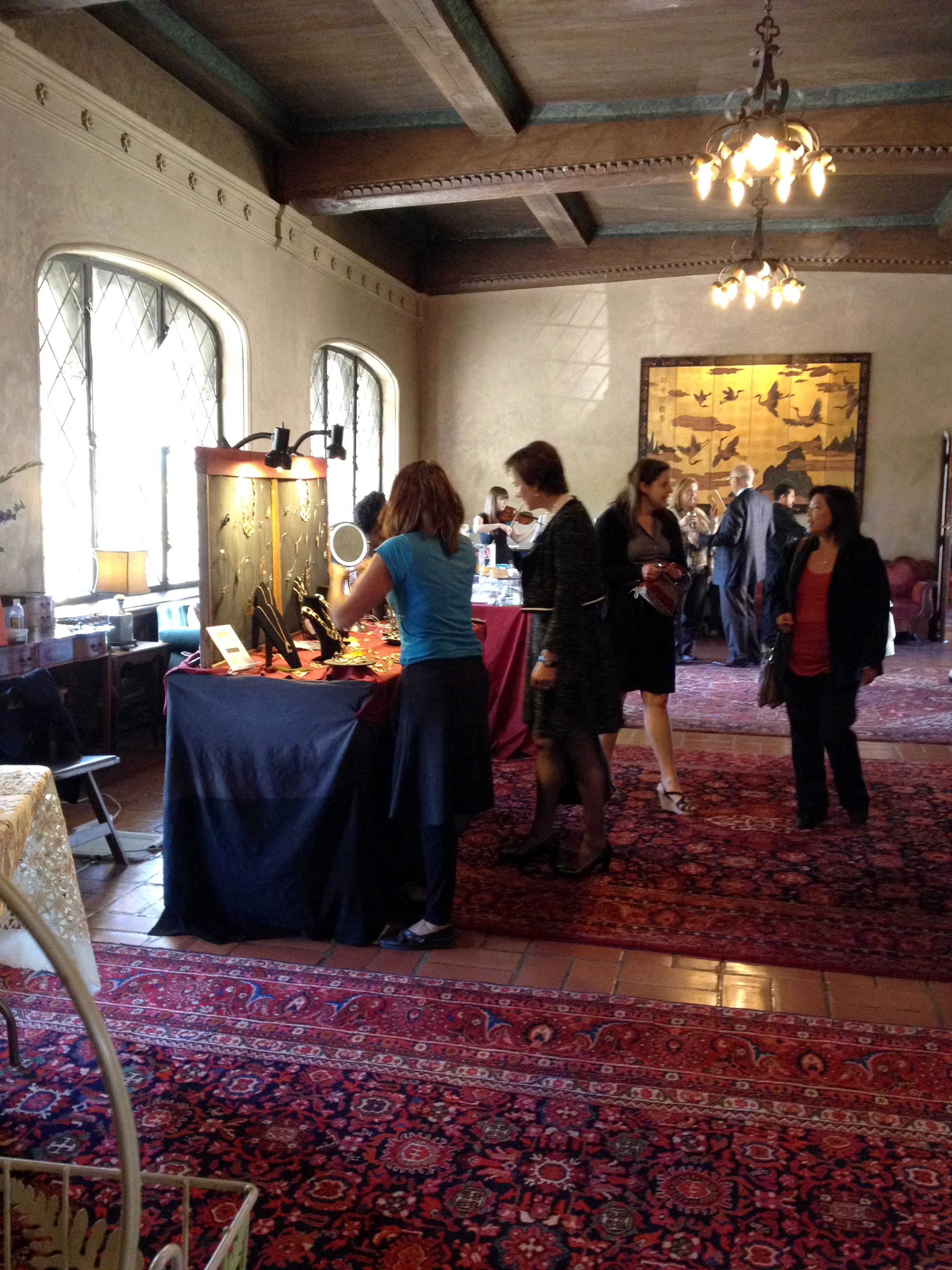 The view from my booth while the ladies are setting up. Yes, that is a violinist performing in the corner.