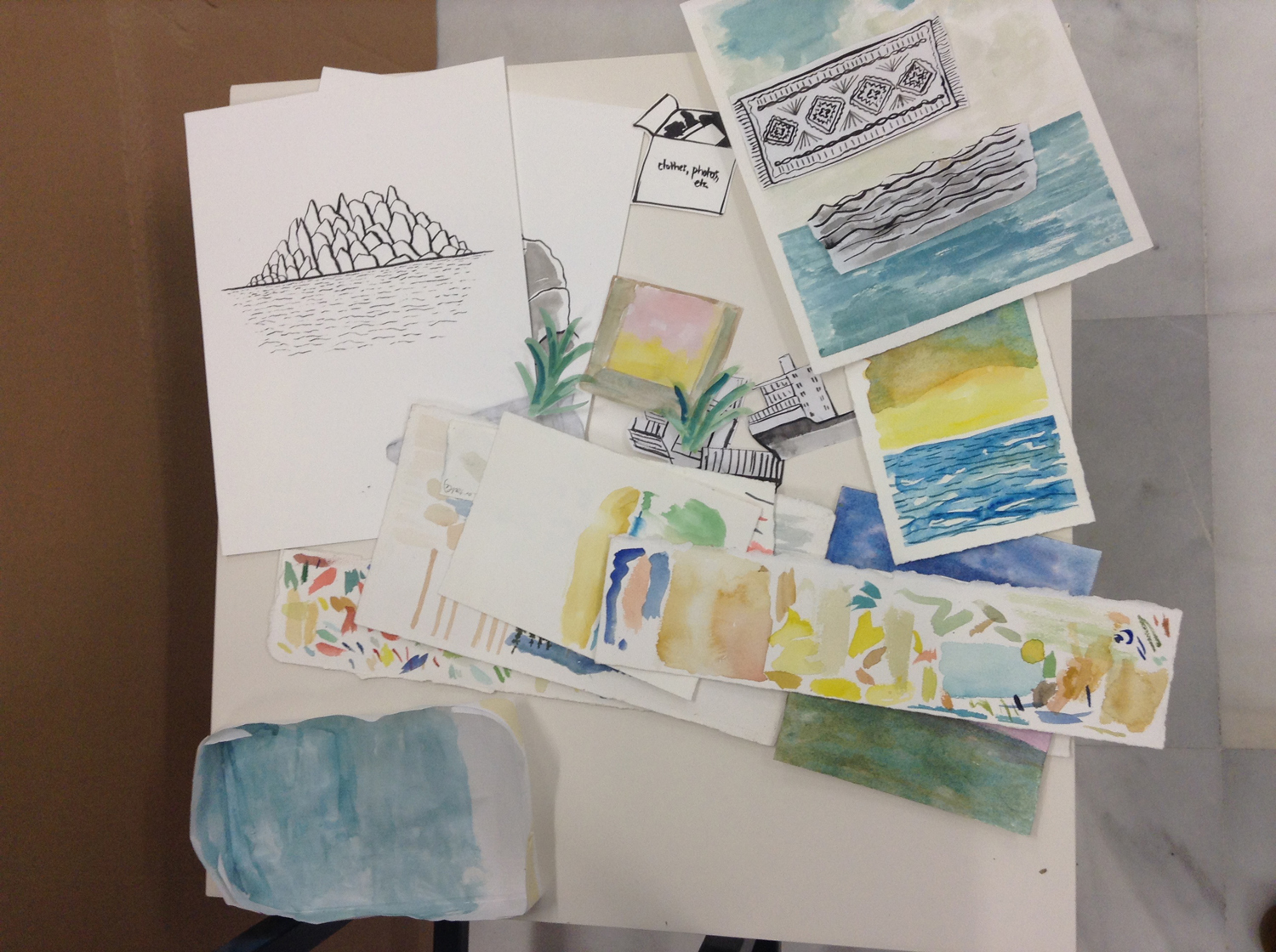 Paint test sheets, cut shapes, ink drawings and watercolor paintings.