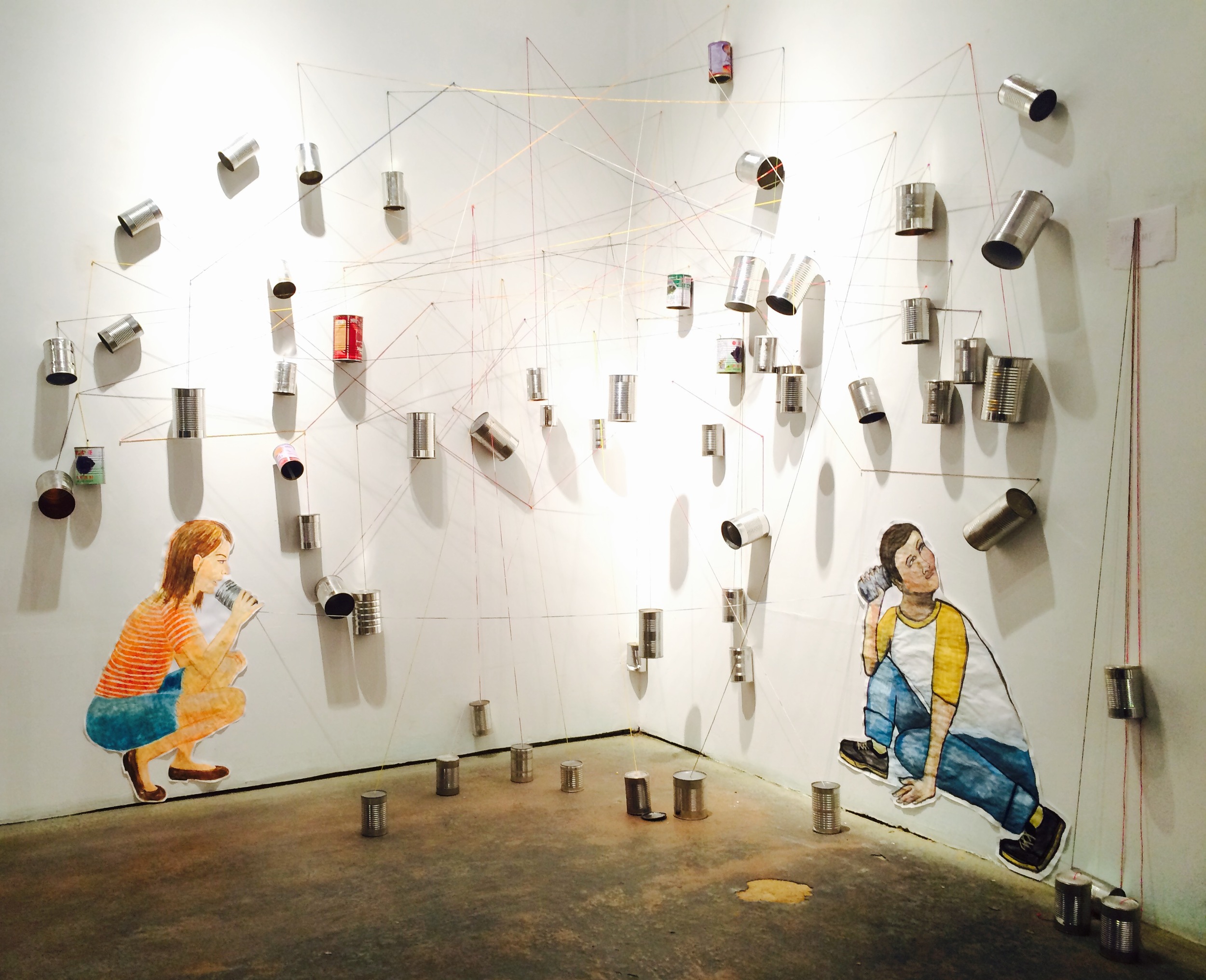 String Theory, art installation by Frances Marin and Anabella Pi ñ on at Citadel Gallery. Watercolor, paper, dyed string and cans. 